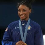 After becoming the third woman in history to win a second Olympic all-around title, Simone Biles wore a diamond-encrusted goat necklace during the medal ceremony.